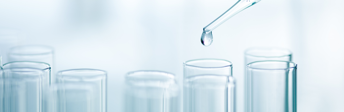 Test tubes with pipette dropping liquid